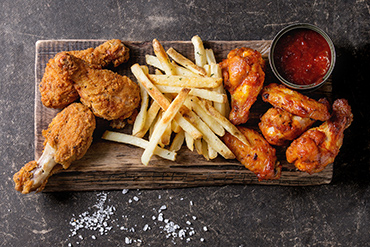 fried chicken wings and french fries with ketchup on the side
