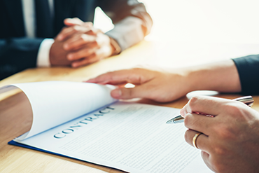 a sales person and a customer reviewing a contract paper